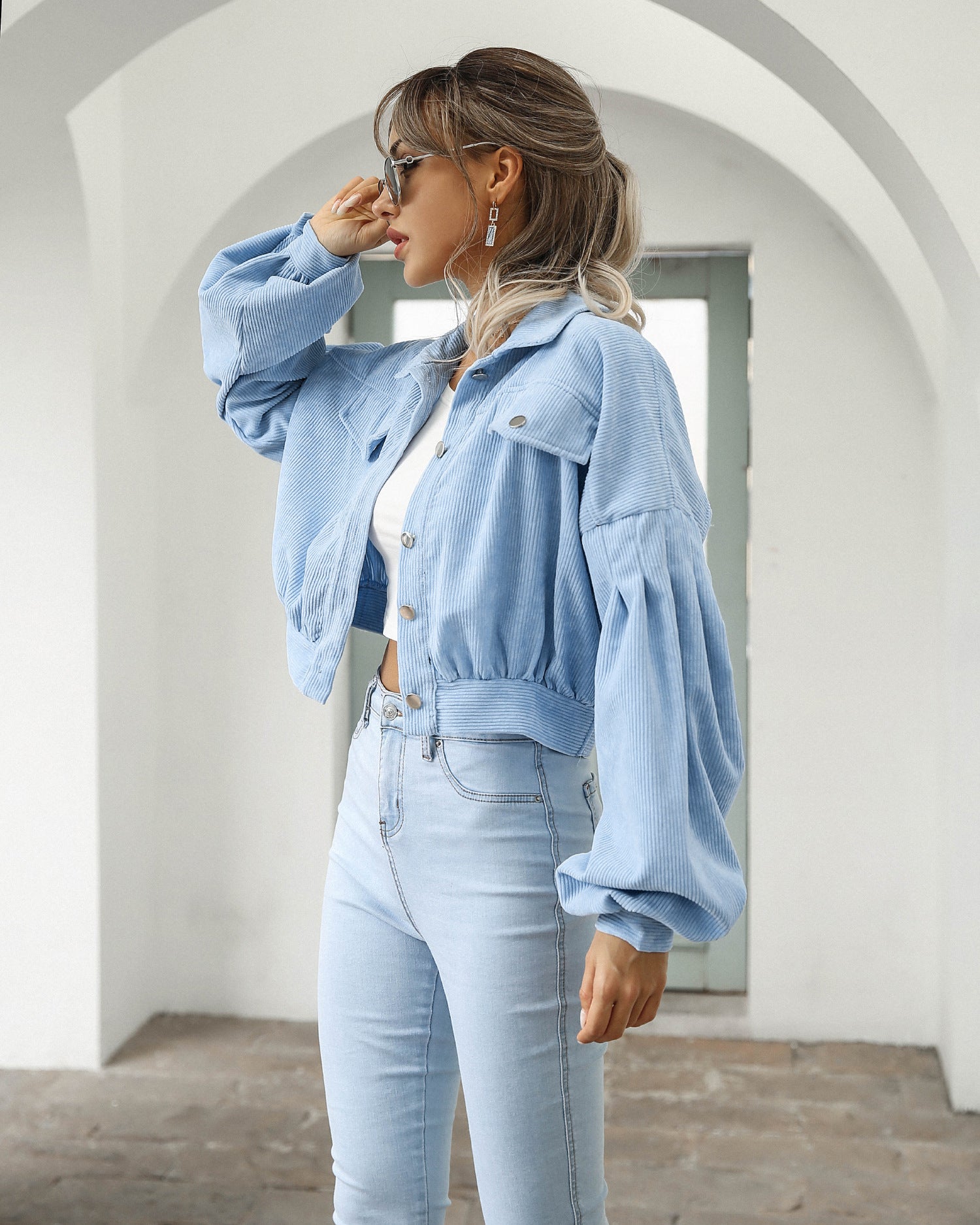 Woman wearing light blue cropped corduroy jacket